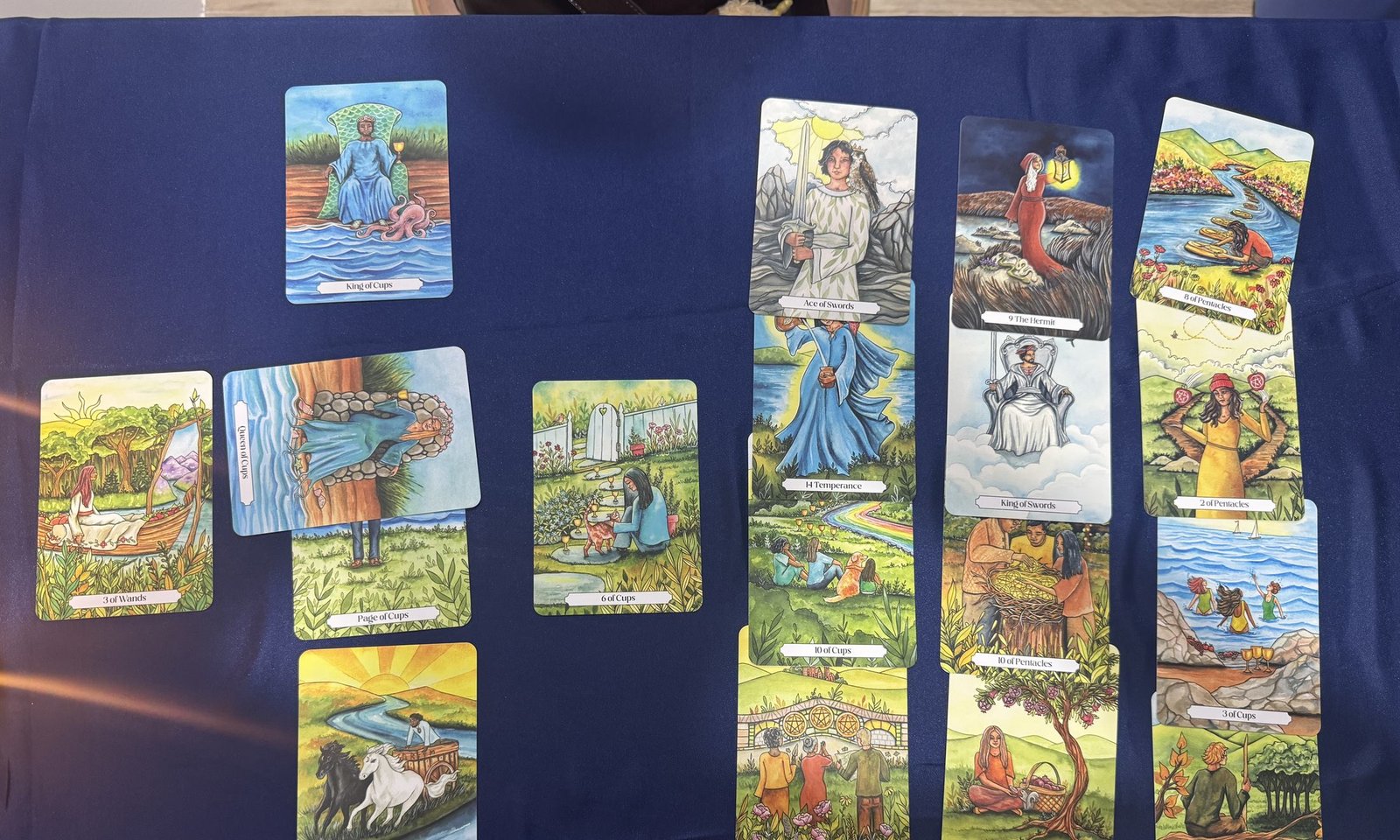 Tarot cards laid out on a navy velvet cloth by candlelight at The Tarot Room